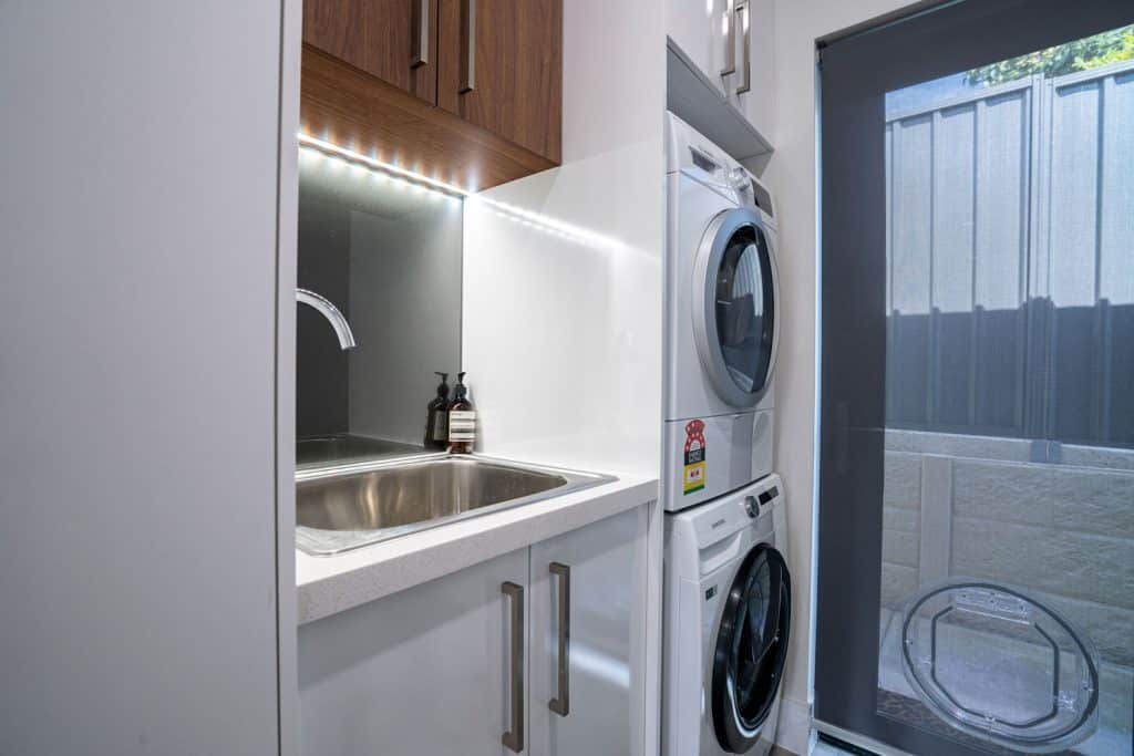 luxury bathroom with stacked washer and dryer